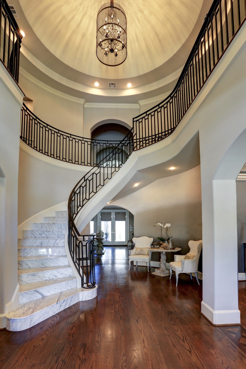 Dramatic entry way with bespoke wrought iron railing and domed ceiling