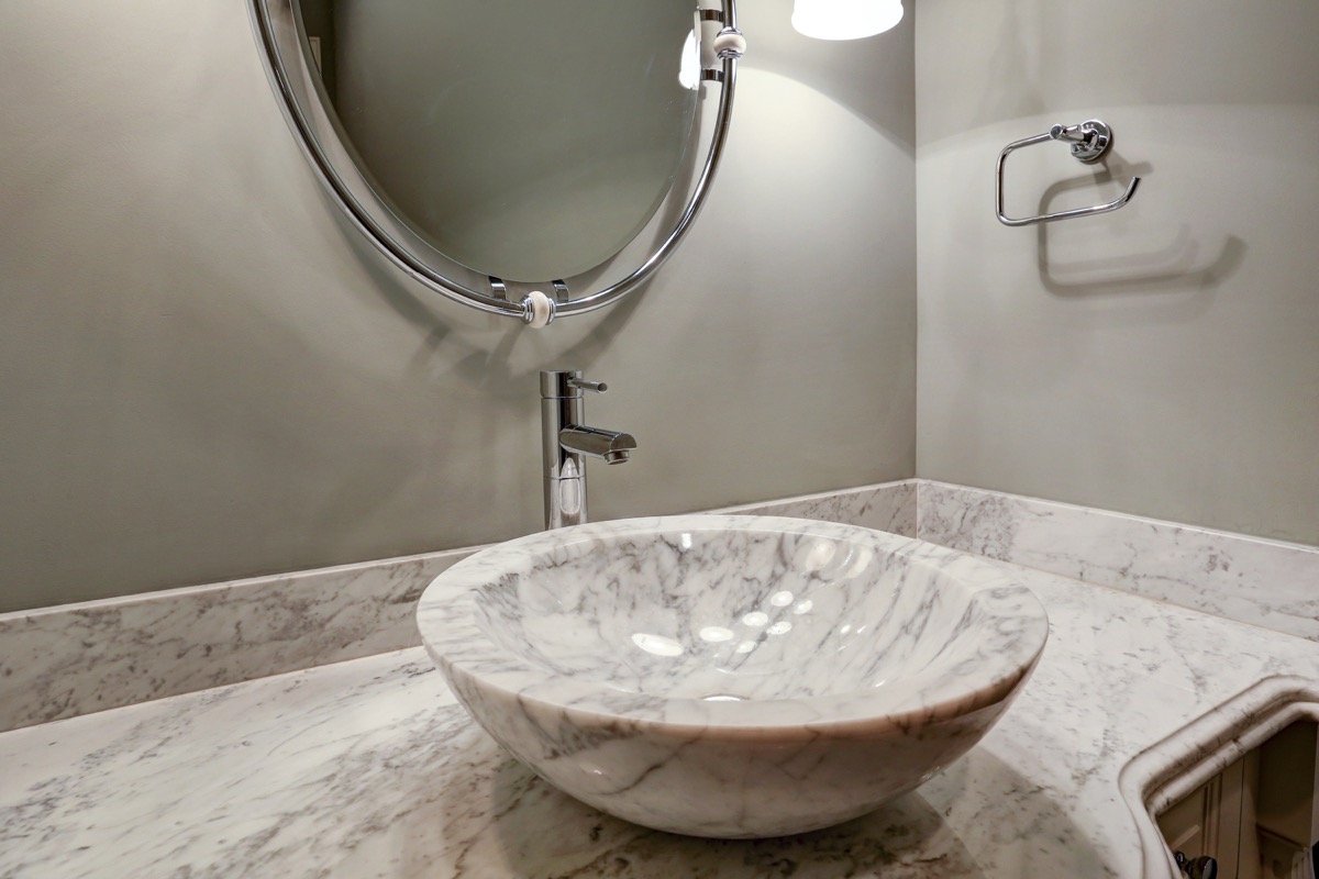 Detailed view of the powder room sink with gorgeous edge of the marble counter