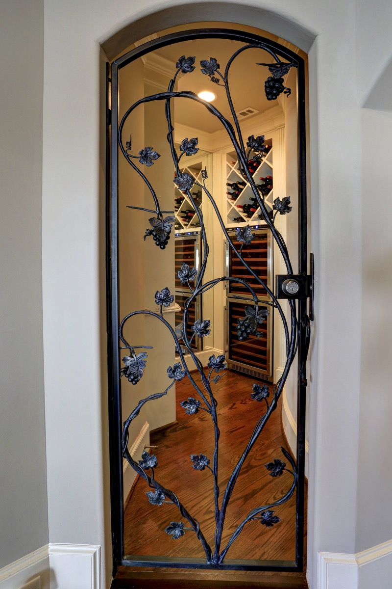Lockable wine room with wrought iron door