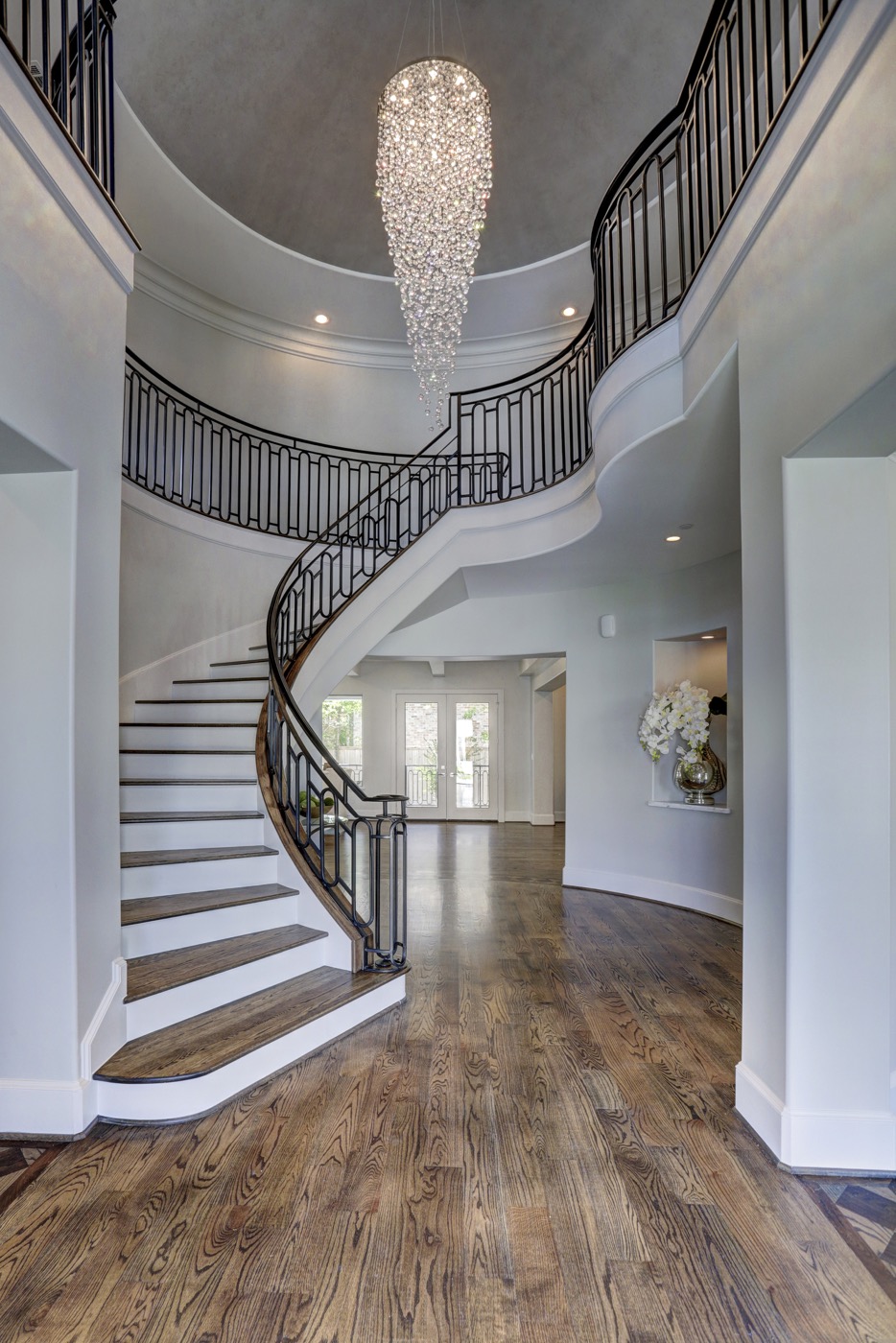 Curved staircase showcases the crystal chandelier