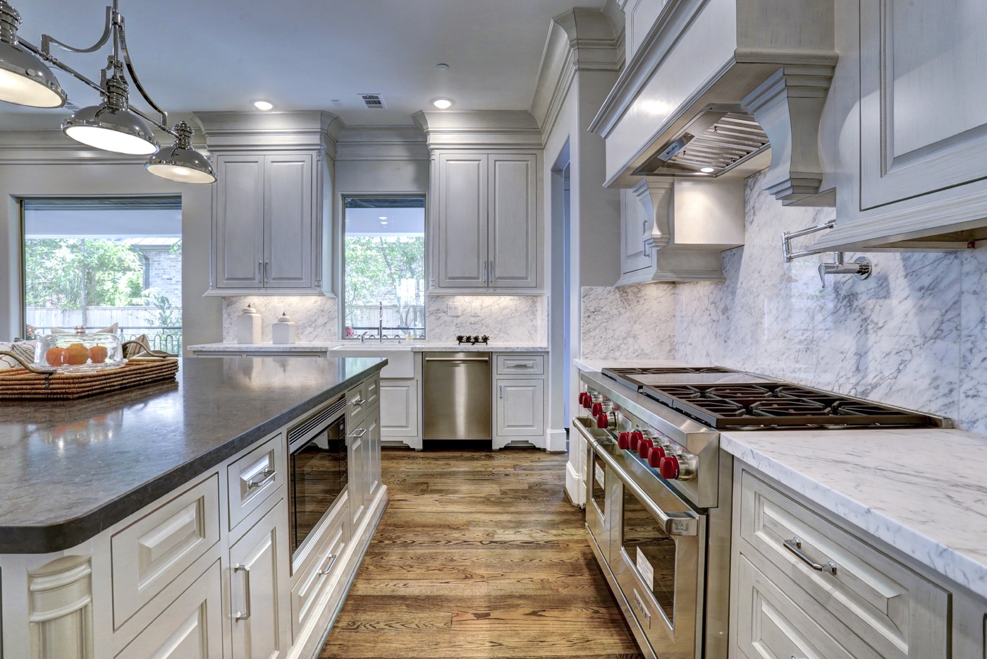 Kitchen boasts Sub-Zero and Wolfe Appliances as well as a pot filler, under-counter lighting, and farmhouse sink