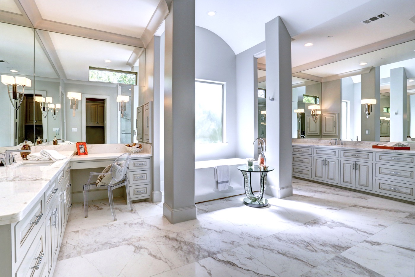 Spacious master bathroom features a modern tub by the frosted window