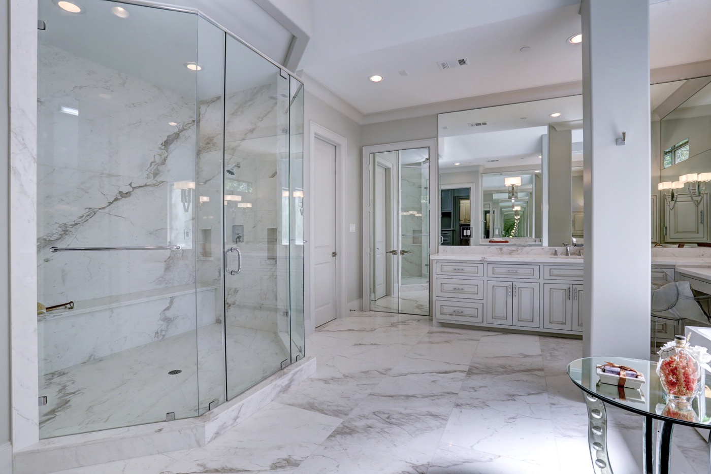 Master bath is clad in slabs of calacatta marble that is book matched for consistency